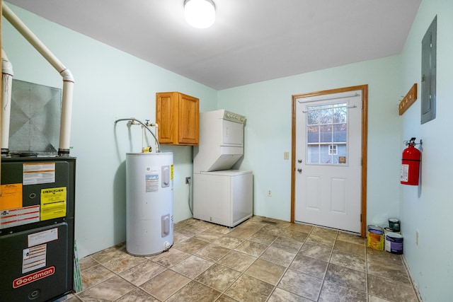 4963 Eastway Dr, Indian River, MI 49749 - clothes washing area featuring electric panel, cabinet space, electric water heater, and stacked washer and dryer