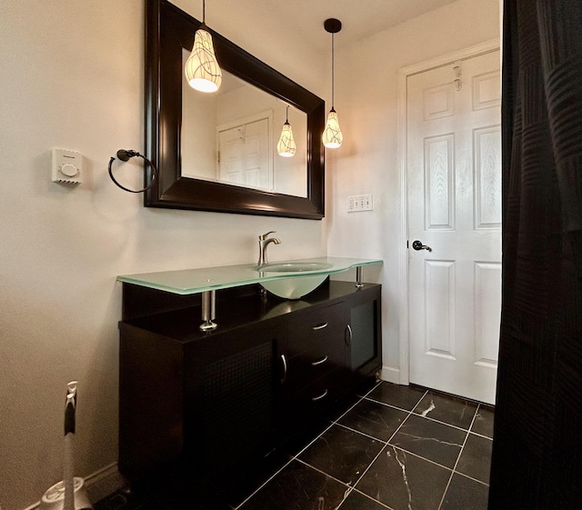 bathroom with vanity and baseboards