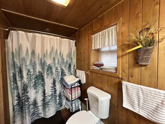 full bathroom featuring curtained shower, wooden walls, toilet, and wood ceiling