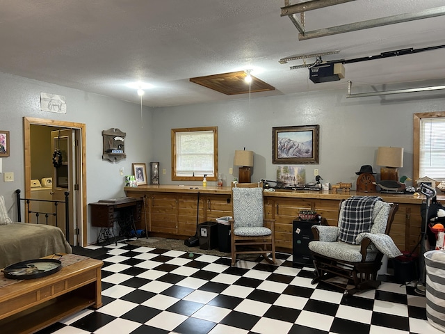 interior space with attic access, dark floors, and a healthy amount of sunlight