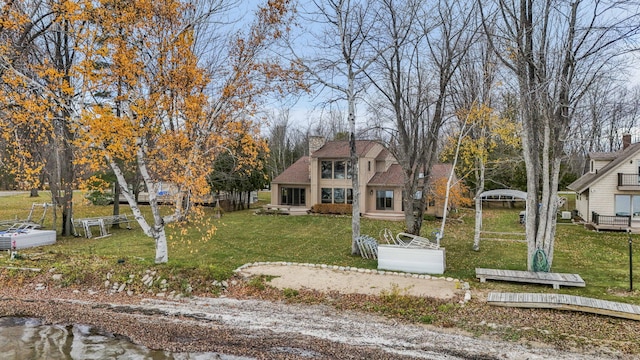 view of front of property featuring a front yard and a chimney