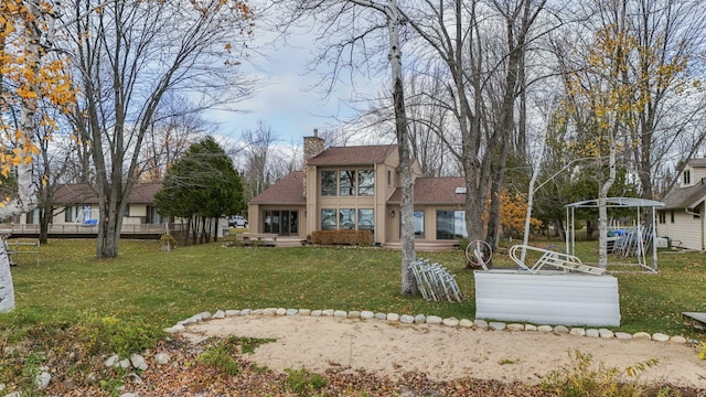 exterior space featuring stucco siding, a chimney, a front lawn, and roof with shingles