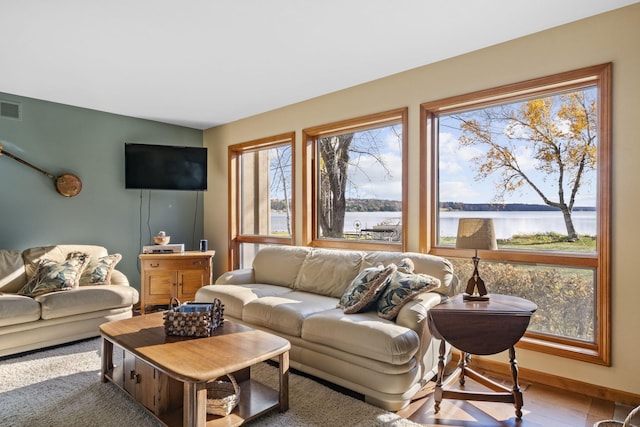 living area featuring visible vents and baseboards