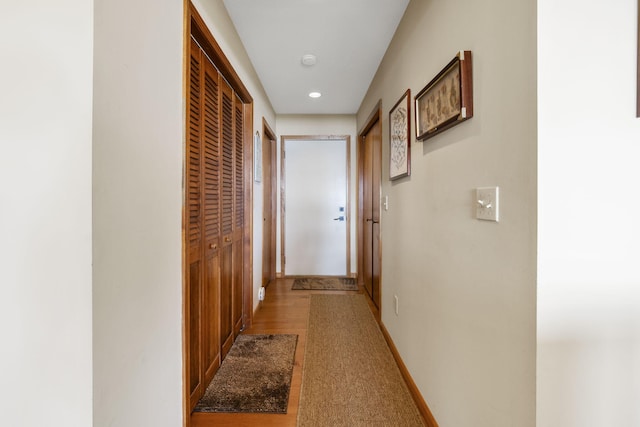 hall featuring recessed lighting and baseboards