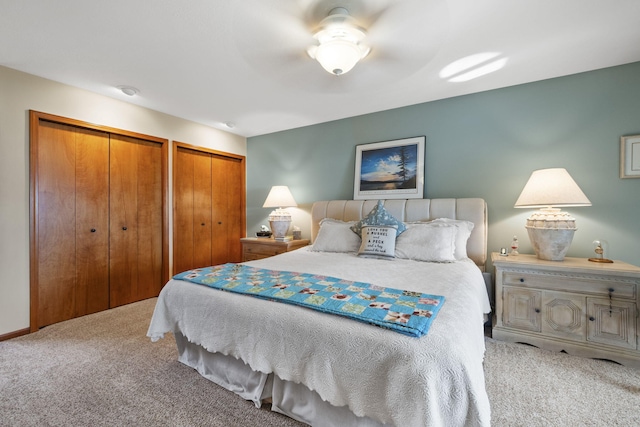 carpeted bedroom with two closets