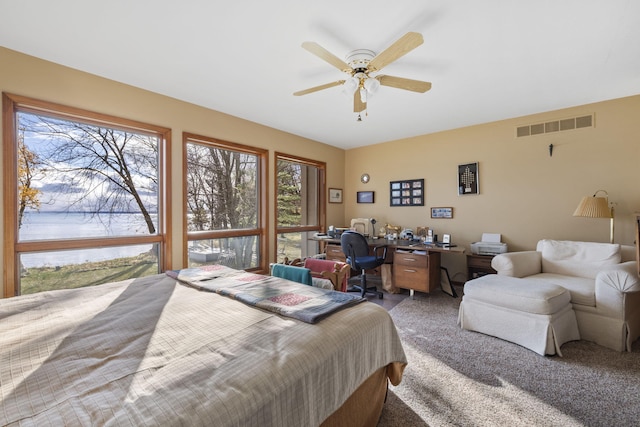 bedroom featuring visible vents, light colored carpet, and ceiling fan