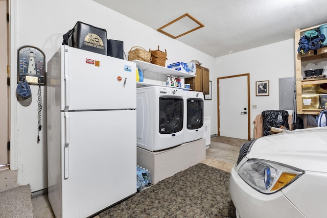 washroom featuring washer and clothes dryer, attic access, electric panel, laundry area, and a textured ceiling