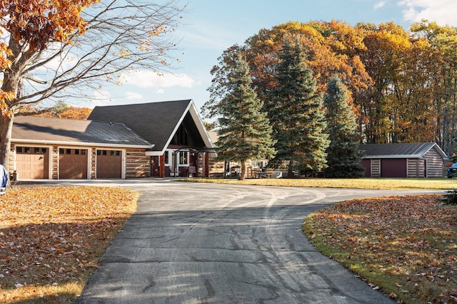 view of home's exterior with aphalt driveway and an attached garage