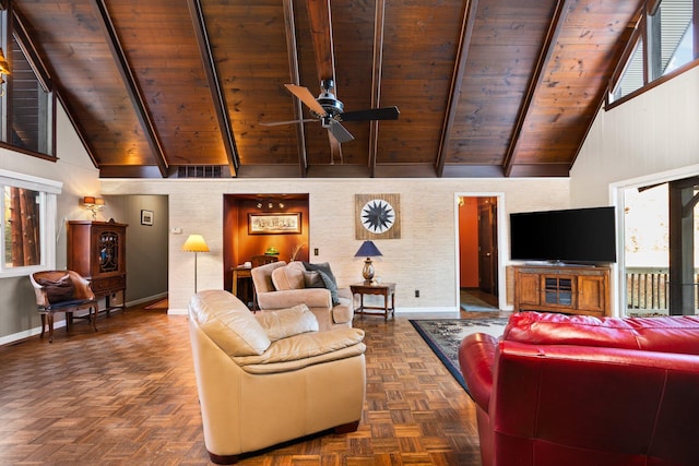 living room featuring plenty of natural light, high vaulted ceiling, and baseboards