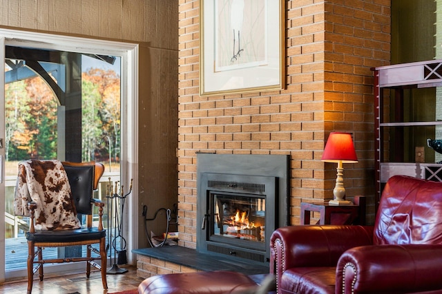 living area featuring a brick fireplace