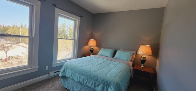 carpeted bedroom featuring a textured ceiling, baseboards, and a baseboard radiator