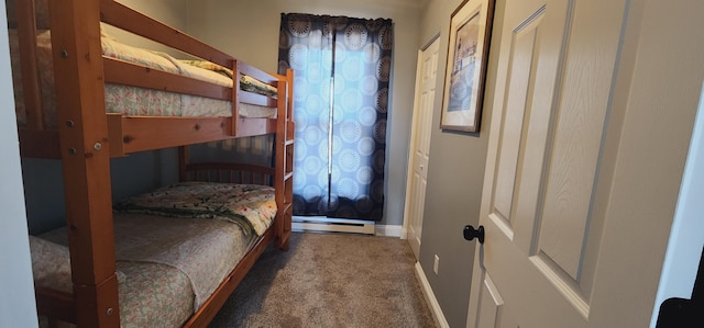 bedroom with a baseboard heating unit, carpet, and baseboards