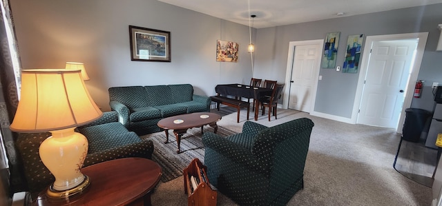 carpeted living area with baseboards