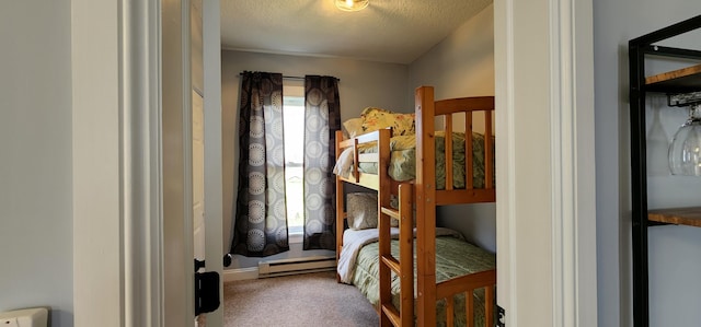 carpeted bedroom featuring a baseboard radiator and a textured ceiling