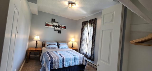 bedroom with baseboard heating, carpet floors, and a textured ceiling