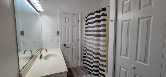 bathroom featuring curtained shower, wood finished floors, and vanity