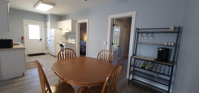 dining area with light wood-style flooring