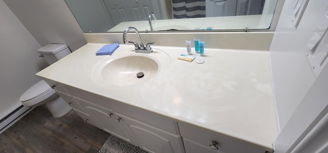 bathroom with vanity, toilet, and wood finished floors