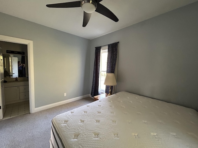 unfurnished bedroom featuring a ceiling fan, a sink, connected bathroom, carpet floors, and baseboards