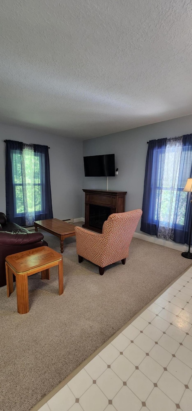 carpeted living room featuring tile patterned floors, a fireplace, and a textured ceiling