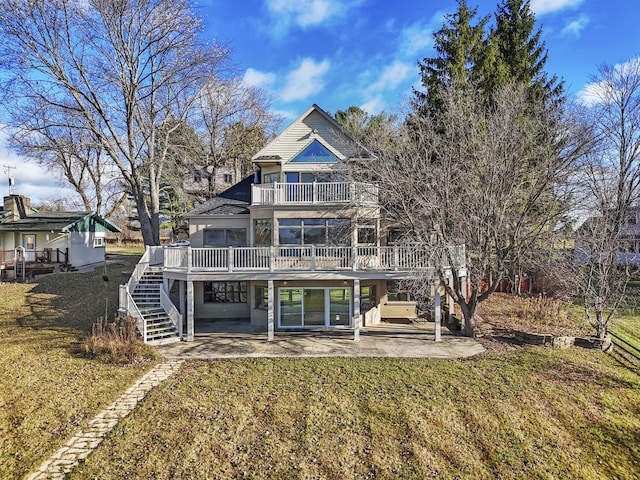 rear view of property with stairs, a patio, a balcony, and a lawn