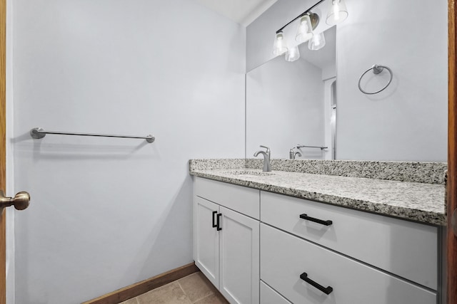 bathroom with baseboards, vanity, and tile patterned flooring