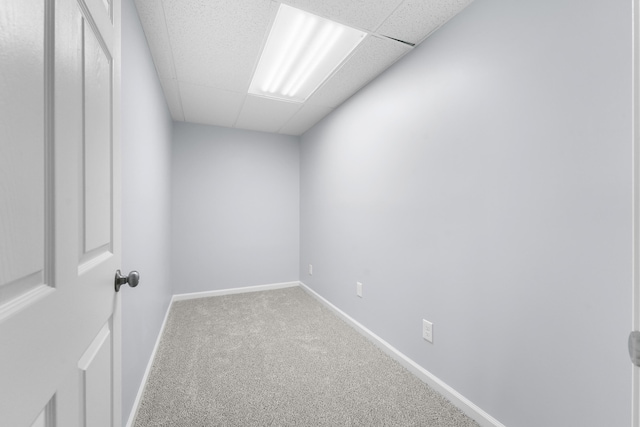 unfurnished room featuring carpet, baseboards, and a paneled ceiling