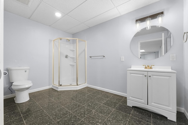 full bathroom featuring a shower stall, toilet, a paneled ceiling, and baseboards