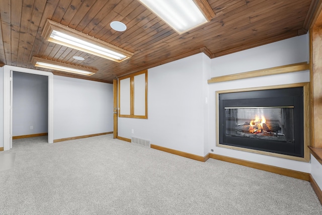 basement with visible vents, a multi sided fireplace, carpet flooring, baseboards, and wood ceiling