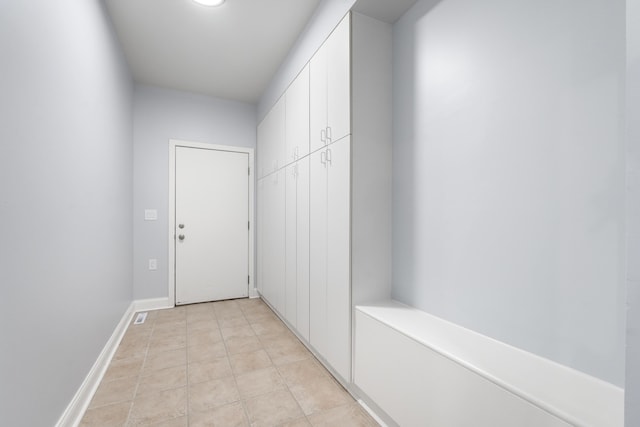 interior space featuring light tile patterned floors and baseboards