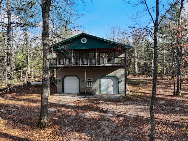 view of outbuilding featuring an attached garage and driveway