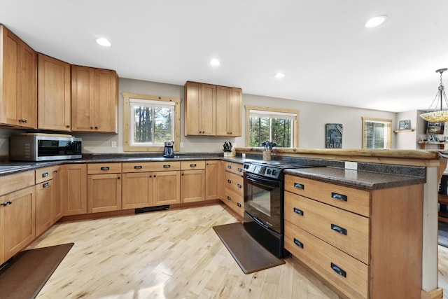 kitchen with dark countertops, a peninsula, electric range, light wood-style floors, and stainless steel microwave