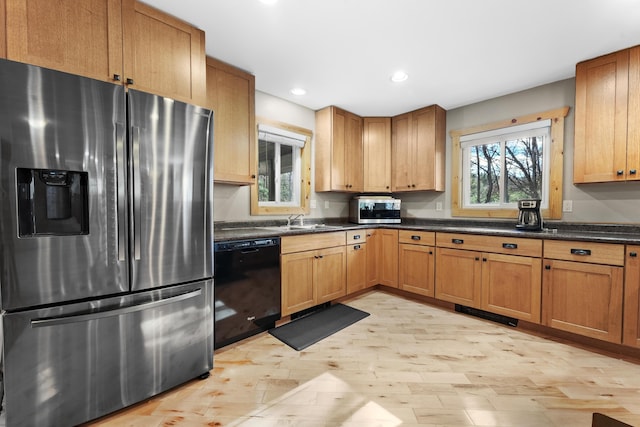 kitchen with recessed lighting, stainless steel appliances, light wood-type flooring, and a sink