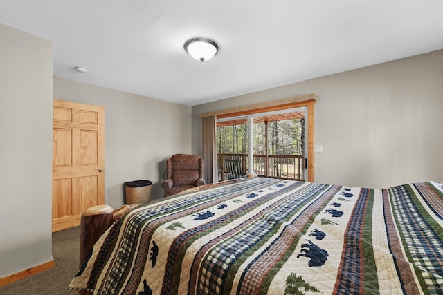 carpeted bedroom featuring baseboards and access to outside