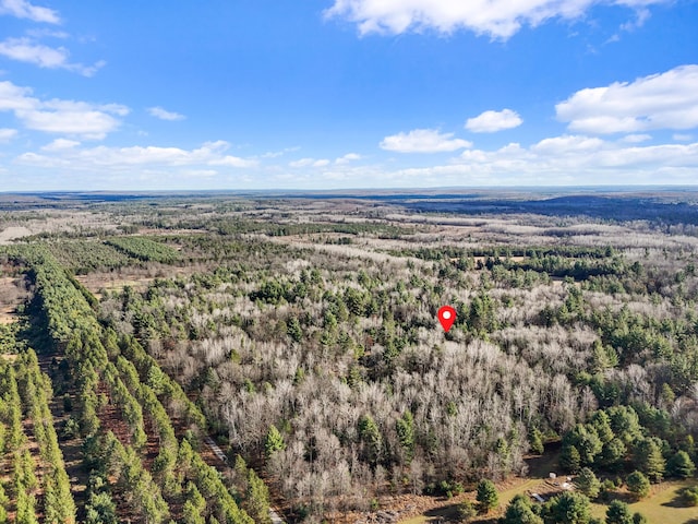 drone / aerial view featuring a wooded view