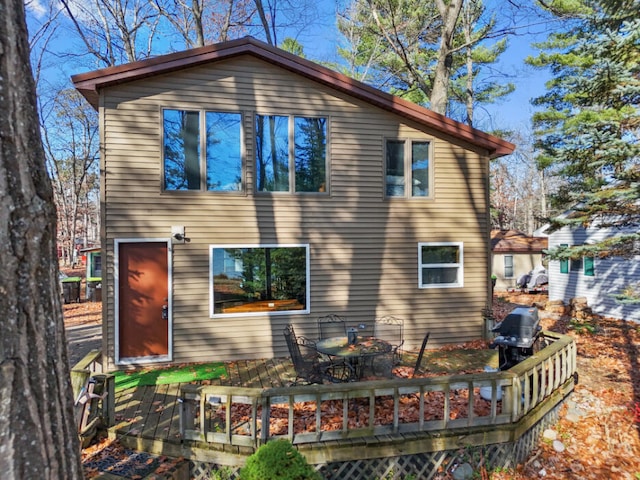 back of property featuring a wooden deck