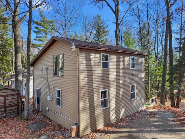 view of side of property with metal roof and an outbuilding