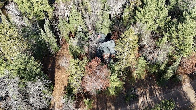 drone / aerial view with a wooded view