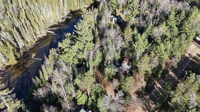 birds eye view of property with a view of trees