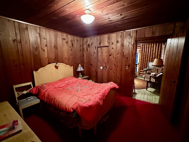 bedroom with wood ceiling and wood walls