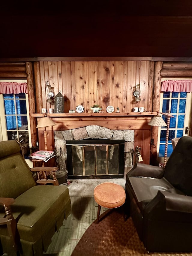 sitting room with a stone fireplace