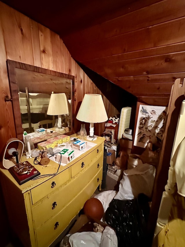 bedroom featuring wood walls and lofted ceiling