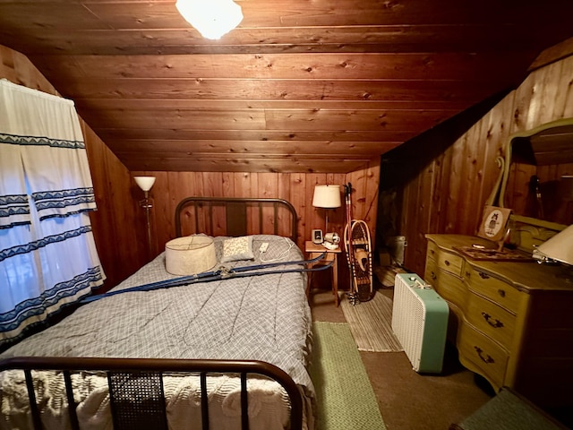 carpeted bedroom with wood walls, wooden ceiling, and vaulted ceiling