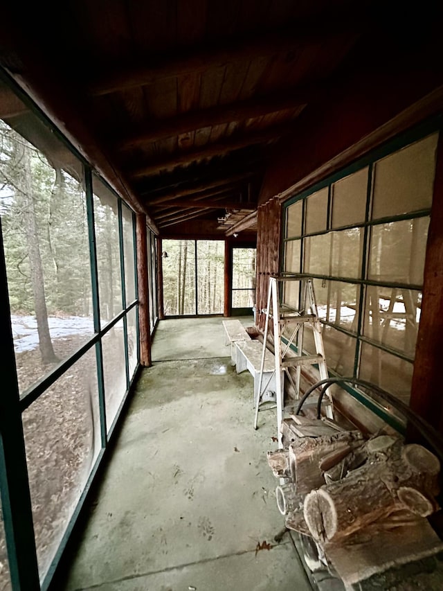 unfurnished sunroom with lofted ceiling