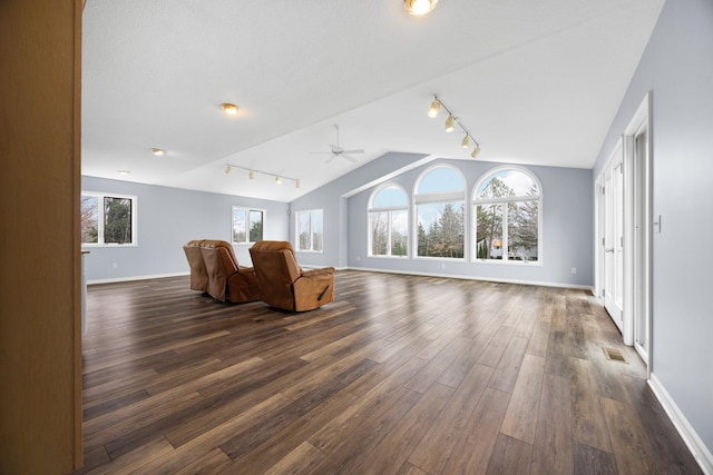 living room featuring visible vents, baseboards, vaulted ceiling, a ceiling fan, and dark wood-style flooring