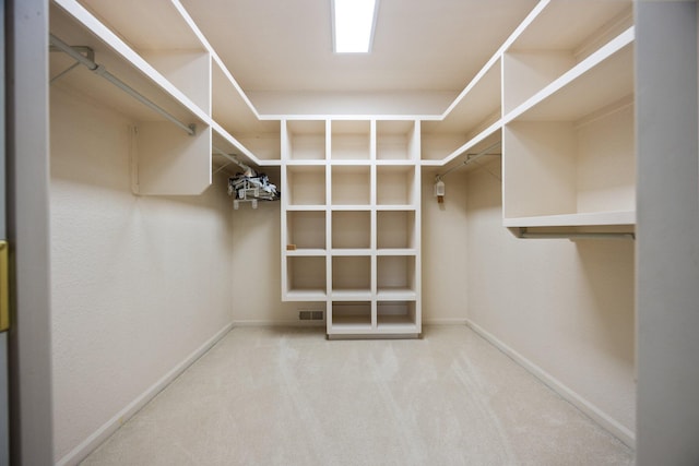 walk in closet featuring visible vents and carpet