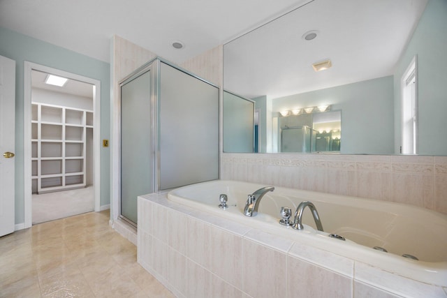 bathroom featuring tile patterned floors, a stall shower, and a garden tub