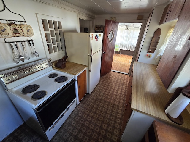 kitchen with white appliances, light countertops, and dark floors