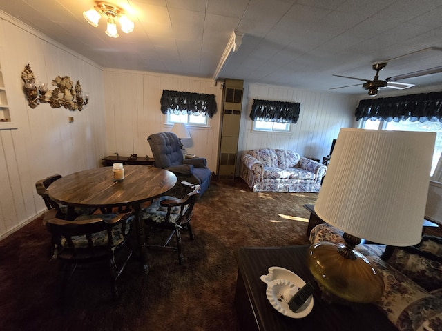 carpeted dining room with ceiling fan