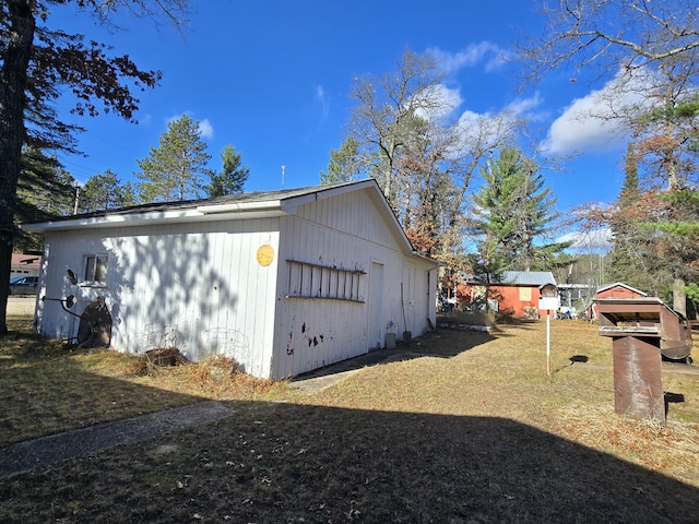 view of property exterior featuring a yard and a garage